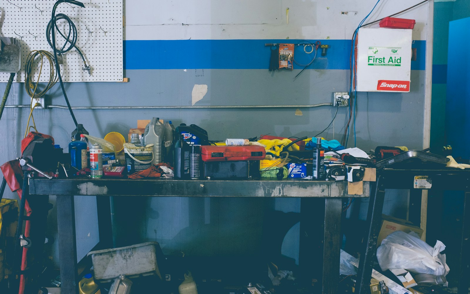 assorted-color handheld tools on work bench
